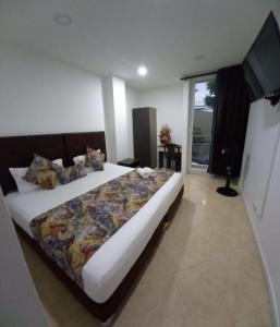 a bedroom with a large bed in a room at Raí home in Medellín