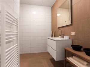 a white bathroom with a sink and a mirror at Zilte Haven in Kamperland +27 photos