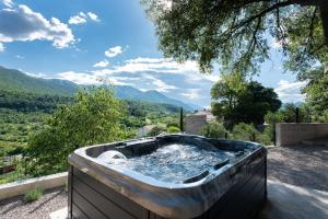 a hot tub with a view of the mountains at Apartment Feel the nature in Slime