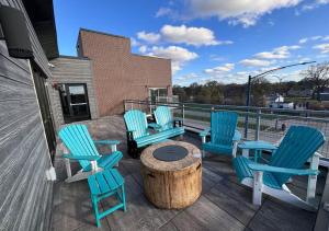 a group of blue chairs sitting on a deck at Golden Fern Escape in Des Moines
