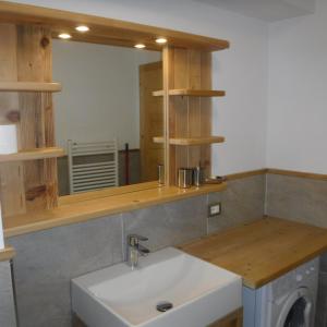 a bathroom with a sink and a mirror at Appartamento Mariastella in Andalo +41 photos