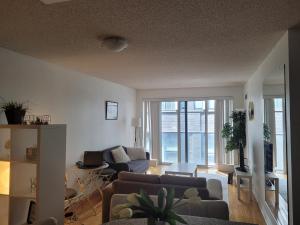 a living room with two couches and a table at Downtown Toronto Condo in Toronto +2 photos