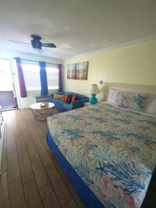 a bedroom with a large bed and a couch at Ocean Front 53 Steps in Myrtle Beach