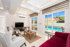 a living room with a red couch and a tv at Villa Central in Dalyan