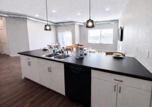 a kitchen with a black counter top and a sink at Casa Marigold in Des Moines