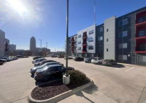 a parking lot with a row of parked cars at Casa Marigold in Des Moines