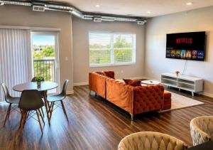 a living room with a couch and a table at Casa Marigold in Des Moines