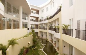 an apartment building with a river in the middle at Hotel Santika Bangka in Pangkalpinang