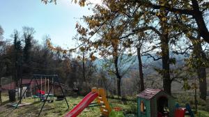 a playground with a slide and a swing at Agriturismo Mirasole in Predappio