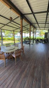 a patio with a table and chairs on a wooden deck at One Piece in Golfito +13 photos