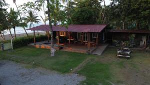a small house with a deck and a table at One Piece in Golfito