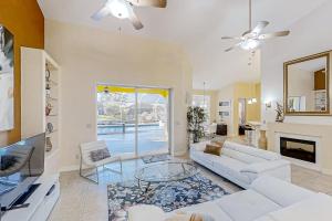a living room with a white couch and a fireplace at Waterfront Hideaway in Cape Coral