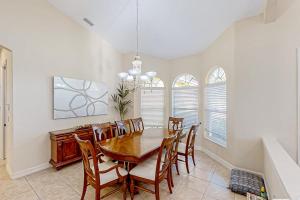 a dining room with a wooden table and chairs at Waterfront Hideaway in Cape Coral