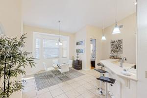 a kitchen with a sink and a table and chairs at Waterfront Hideaway in Cape Coral +19 photos
