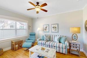 a living room with a couch and a ceiling fan at Vintage Venice Duplex - A in Venice