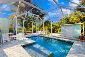 a swimming pool with a pergola next to a house at Vintage Venice Duplex - A in Venice