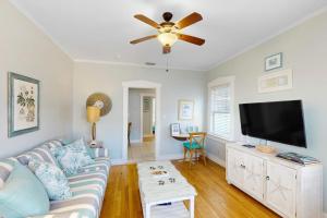 a living room with a couch and a flat screen tv at Vintage Venice Duplex - A in Venice