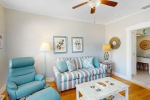 a living room with a couch and a table at Vintage Venice Duplex - A in Venice