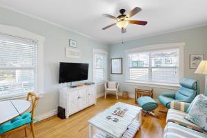 a living room with a flat screen tv and a couch at Vintage Venice Duplex - A in Venice +16 photos