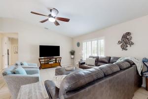 a living room with a couch and a ceiling fan at No Regrets in Englewood