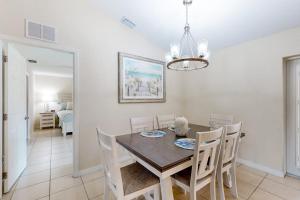 a dining room with a table and chairs at No Regrets in Englewood