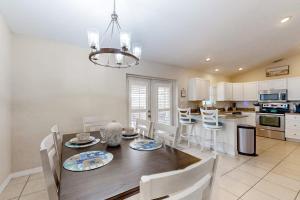 a kitchen with a table and chairs and a dining room at No Regrets in Englewood