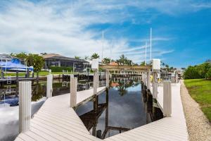 a dock with a bridge over a body of water at Marco Island Majesty in Marco Island