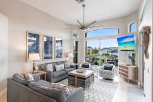 a living room with two couches and a table at Marco Island Majesty in Marco Island