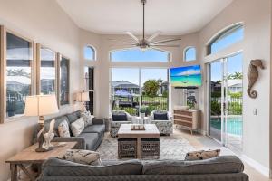 a living room with a couch and a table at Marco Island Majesty in Marco Island