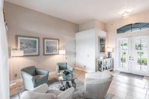 a living room with two chairs and a table at Marco Island Majesty in Marco Island