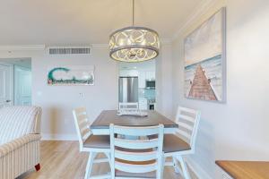 a dining room with a table and chairs and a chandelier at Marco Beach Ocean Resort 801 in Marco Island +36 photos