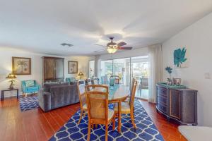a dining room and living room with a table and chairs at Marco Island Manor in Marco Island
