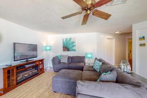 a living room with a couch and a flat screen tv at Marco Island Manor in Marco Island +17 photos
