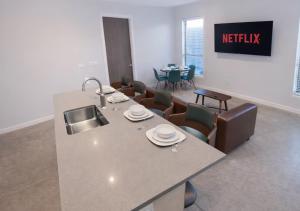 a kitchen with a table and chairs in a room at Cozy Greenwood Canopy in Des Moines