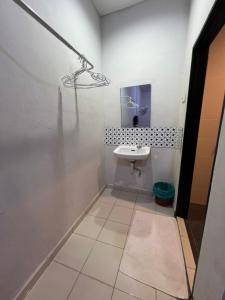 a white bathroom with a sink and a mirror at Little Chenang Cottage Motel Langkawi in Pantai Cenang +135 photos