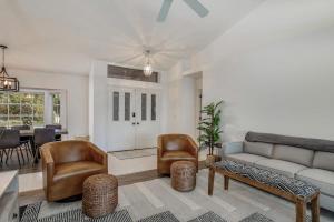 a living room with a couch and chairs and a table at Hook, Line, and Sunsets in Port Charlotte
