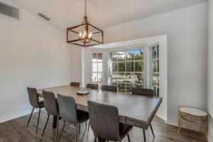 a dining room with a wooden table and chairs at Hook, Line, and Sunsets in Port Charlotte