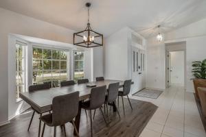 a dining room with a large table and chairs at Hook, Line, and Sunsets in Port Charlotte +36 photos