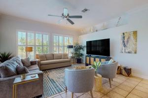 a living room with a couch and a flat screen tv at Endless Summer in Cape Coral