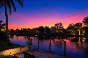a view of a lake with a sunset at Endless Summer in Cape Coral