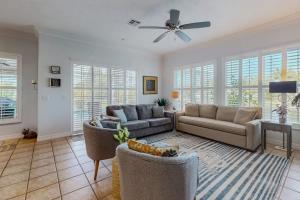 a living room with two couches and a ceiling fan at Endless Summer in Cape Coral