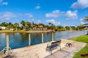 a bench sitting next to a body of water at Endless Summer in Cape Coral