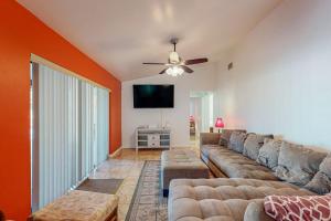 a living room with a couch and a flat screen tv at Cape Escape in Cape Coral