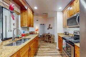 a kitchen with a sink and a stove top oven at Cape Escape in Cape Coral +22 photos