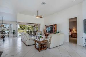 a living room with couches and a table at Sable Retreat in Cape Coral