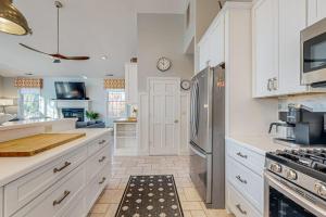 a kitchen with white cabinets and a stainless steel refrigerator at Rehoboth Beach --- 21163 Bayview Rd. in Dewey Beach +17 photos