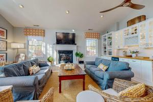 a living room with blue couches and a fireplace at Rehoboth Beach --- 21163 Bayview Rd. in Dewey Beach