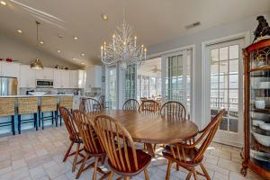 a dining room with a table and chairs and a kitchen at Rehoboth Beach --- 21163 Bayview Rd. in Dewey Beach