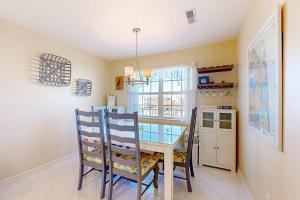 a dining room with a table and chairs and a window at Bethany Bay --- 37182 Harbor Dr #2606 in Ocean View