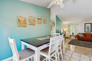 a dining room and living room with a table and chairs at Ocean Way Estates - 32563 W Riga Dr in Ocean View +17 photos